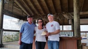 The January winners: from left: Danny Pletsch, Megan Magill Pletsch, and Peter Beardsley